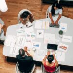 Marketing That Builds Connections and Drives Success. Group of professionals surrounding a table while collaborating on a marketing strategy.