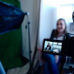 woman doing an interview in front of a camera